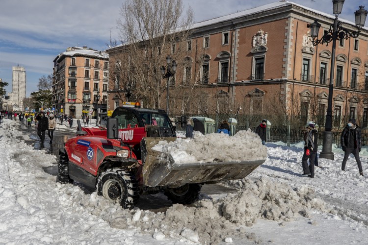 A plow clears snow in downtown Madrid on Sunday after the country was hit with the worst snowstorm in recent memory. 