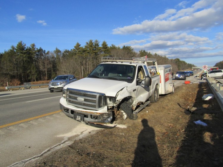 A damaged 2002 Ford Super Duty pickup towing a U-Haul trailer sits beside the southbound lanes of the Maine Turnpike on Tuesday after the driver, David Stoddard, 49, of Topsham, led police on a high-speed chase from Kennebunk to York, according to Maine State Police. The pursuit ended when Stoddard crashed near mile marker 4.