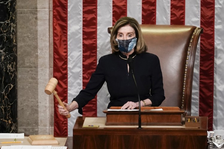 Speaker of the House Nancy Pelosi, D-Calif., gavels in the final vote of the impeachment of President Trump, for his role in inciting an angry mob to storm the Congress last week, at the Capitol in Washington on Wednesday.