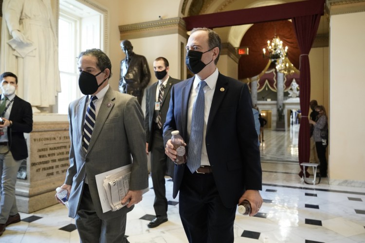 Rep. Jamie Raskin, D-Md., left, walks with Rep. Adam Schiff, D-Calif., at the Capitol in Washington, on Wednesday as the House pursues an article of impeachment against President Trump for his role in inciting an angry mob to storm the Capitol.

