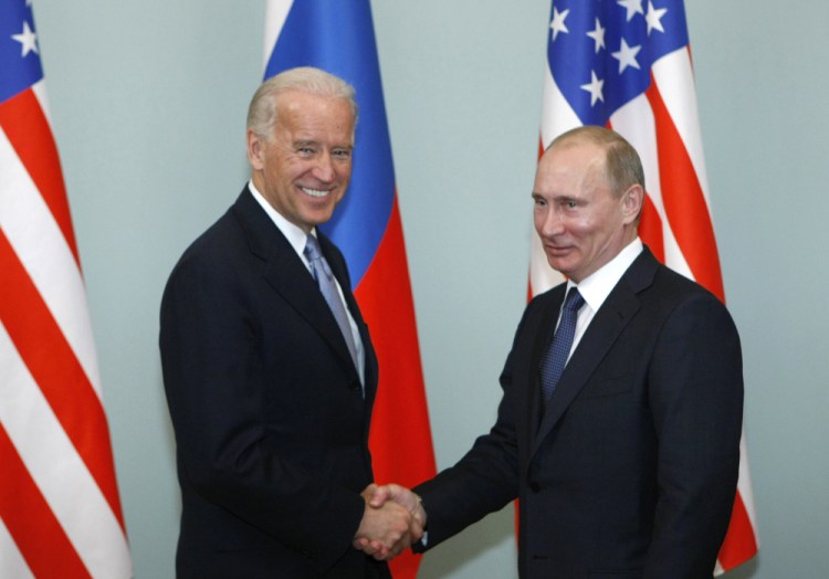 Then-Vice President Joe Biden shakes hands with Russian Prime Minister Vladimir Putin in Moscow, Russia, in 2011. President  Biden has been thrown into a high-wire act with Russia as he seeks to toughen his administration's stance against Putin while preserving room for diplomacy in a post-Donald Trump era. 