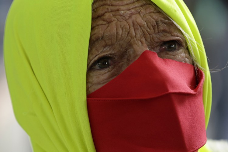 A woman participates in a protest against Brazilian President Jair Bolsonaro's handling of the pandemic in Brazilia on Dec. 23.
