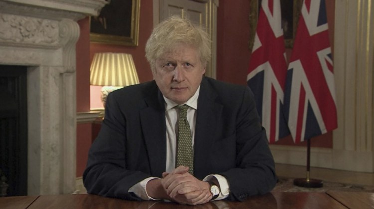 In this image taken from video, Britain's Prime Minister Boris Johnson makes a televised address to the nation from 10 Downing Street, London, on Monday, setting out new emergency measures to control the spread of coronavirus in England.
