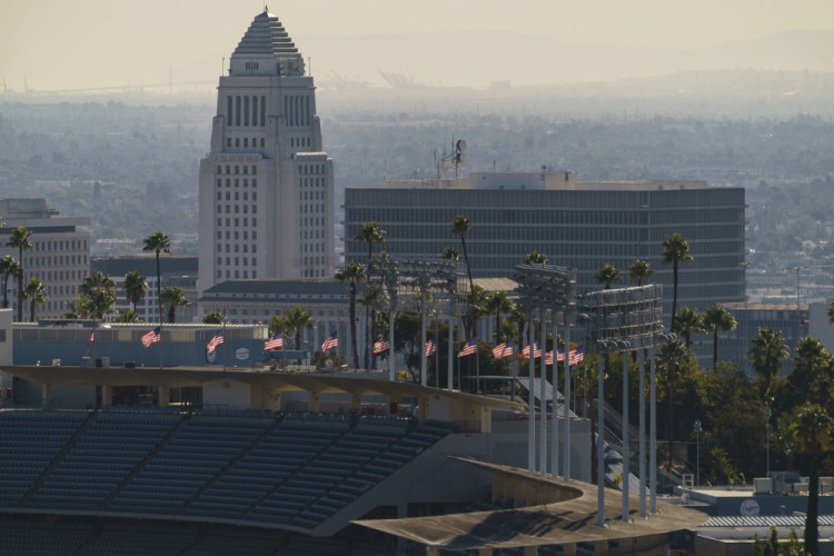 California will vastly expand its effort with new mass vaccination sites at parking lots for Dodger Stadium in Los Angeles, shown here, Petco Park in San Diego and the CalExpo fairgrounds in Sacramento. 