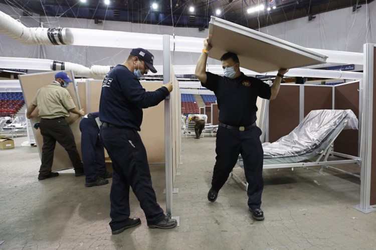Partitions are installed April 18 between beds as work is performed to turn Sleep Train Arena into a 400-bed emergency field hospital to help deal with the coronavirus, in Sacramento, Calif. 