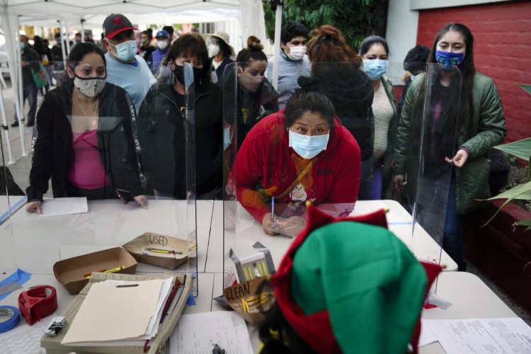 People check in at a food bank in Los Angeles in December.