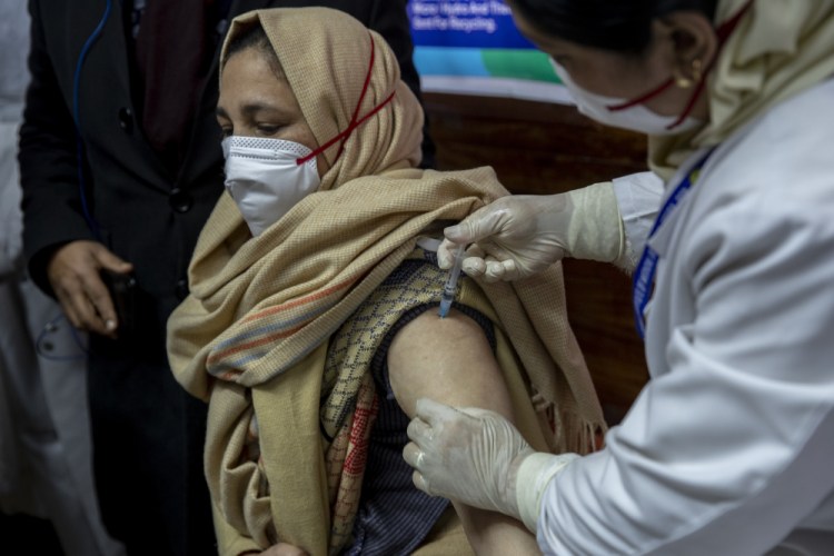 A hospital worker receives a COVID-19 vaccine at a government hospital in Srinagar, Indian controlled Kashmir, on Saturday.



