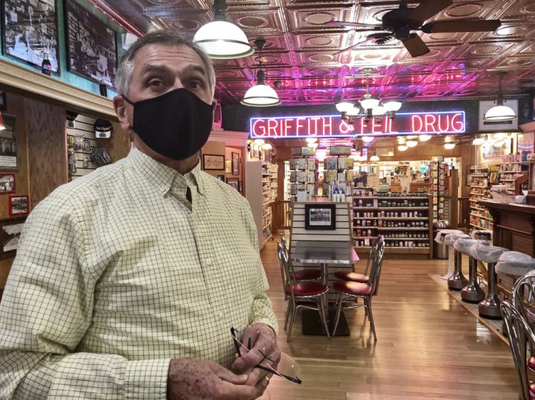 Pharmacist Ric Griffith stands in his family's business Friday, in Kenova, W.Va. Griffith & Feil is among 250 mom-and-pop pharmacies in West Virginia helping to vaccinate residents in the quest to banish the coronavirus pandemic. 