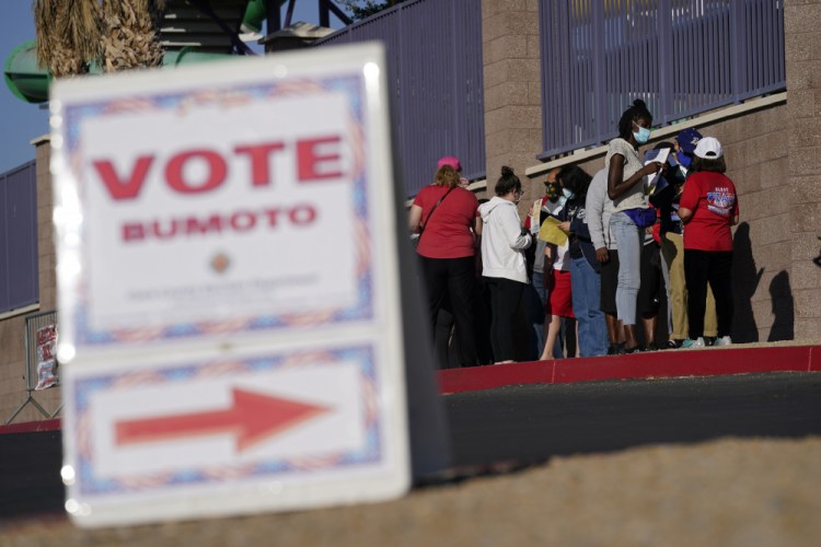 People wait in line to vote at a polling place on Election Day 2020 in Las Vegas. Republican efforts to restrict voting access are taking shape in statehouses across the country with a flurry of legislation aimed at limiting measures that led to record turnout in the 2020 presidential election. (AP Photo/John Locher, File)
