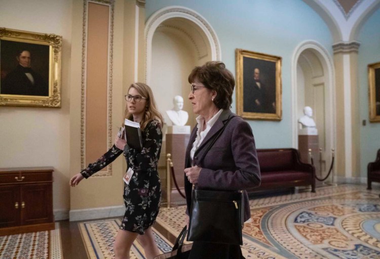 Walking with her director of scheduling Darci Greenacre of Hampden, Sen. Susan Collins, R-Maine, arrives as defense arguments by the Republicans resume in the impeachment trial of President Donald Trump on charges of abuse of power and obstruction of Congress, at the Capitol in Washington, Monday, Jan. 27. 