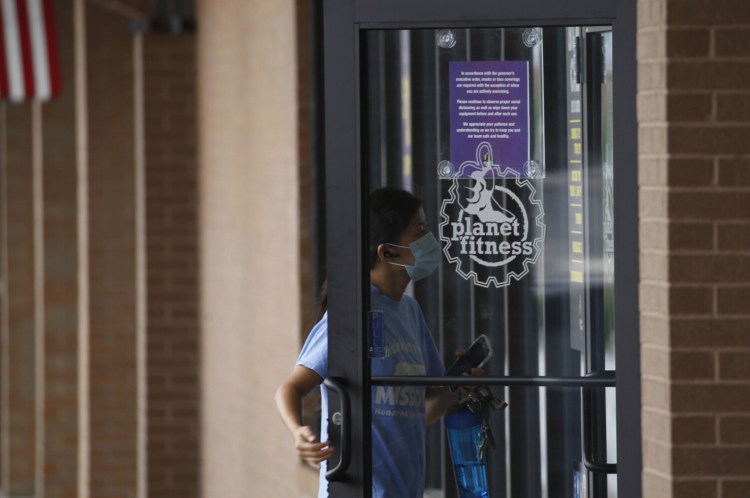 A patron enters a Planet Fitness location in Louisville, Kentucky. The chain's CEO sees virtual options becoming a permanent fixture of gyms. MUST CREDIT: Bloomberg photo by Luke Sharrett