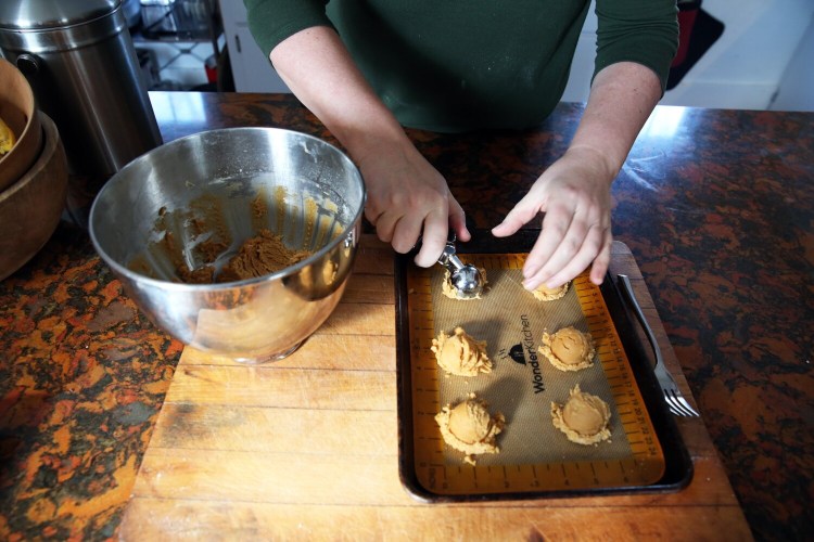 BRUNSWICK, ME - FEBRUARY 11: Christine Burns Rudalevige scoops chickpea cookie dough onto a cookie sheet. (Staff photo by Ben McCanna/Staff Photographer)