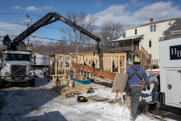 WESTBROOK, ME - FEBRUARY 11: A crew works on framing the first floor of a multi-family building on Main Street in Westbrook on Thursday, February 11, 2021. Because of a zoning change to allow greater downtown density, developer Chris Wilson was able to add a third floor and double the number of apartments. (Staff photo by Brianna Soukup/Staff Photographer)