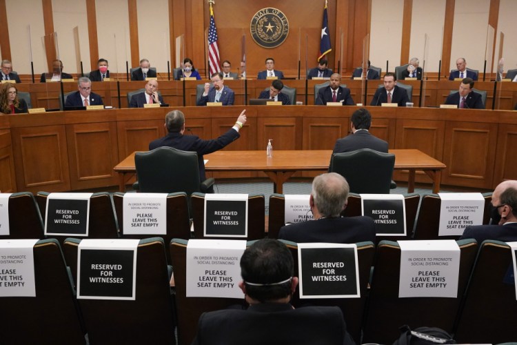 Curtis Morgan, the CEO of Vistra Corp., at table left, testifies as the Committees on State Affairs and Energy Resources holds a joint public hearing to consider the factors that led to statewide electrical blackouts, Thursday in Austin, Texas.