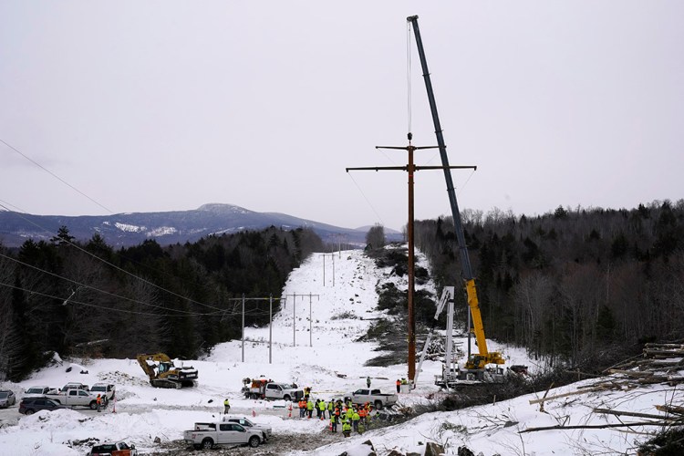 The first pole of Central Maine Power's controversial hydropower transmission corridor is prepared to be installed, Tuesday, Feb. 9, 2021, near The Forks, Maine. The pole was erected on an existing corridor that had been widened near Moxie Pond. (AP Photo/Robert F. Bukaty)