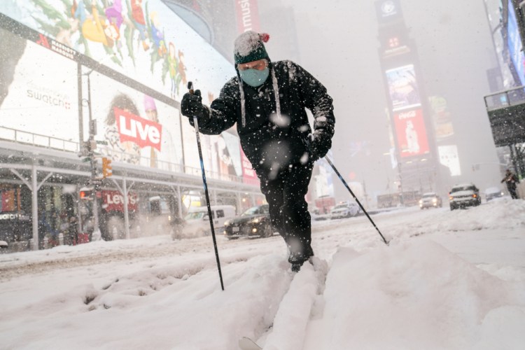 Steve Kent skis through Times Square during a snowstorm on Monday in the Manhattan borough of New York. 