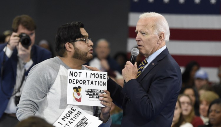 Democratic presidential hopeful Joe Biden talks with a protester objecting to his stance on deportations during a town hall at Lander University in Greenwood, S.C., on  Nov. 21, 2019.  One of the Trump-era orders that's being left as of now is the emergency pandemic measure,  which allows border authorities to rapidly "expel" back to Mexico those who cross the border without documentation. 
