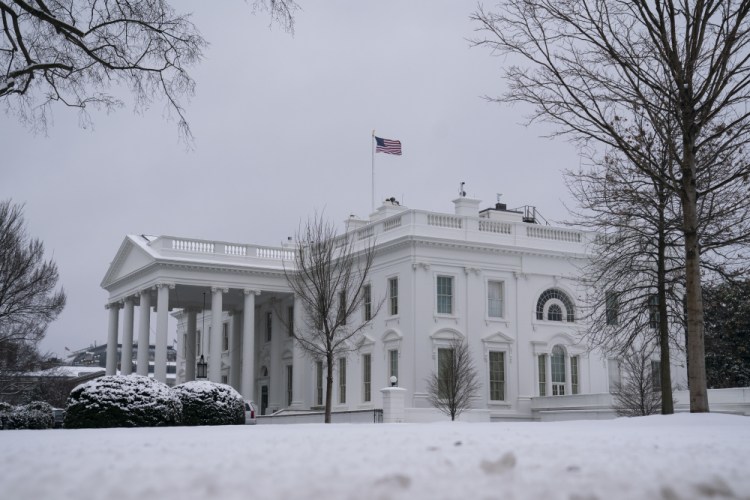 Snow covers the ground at the White House on Monday in Washington. President Biden was meeting Monday with 10 Republican senators about their alternative COVID-19 relief package.  