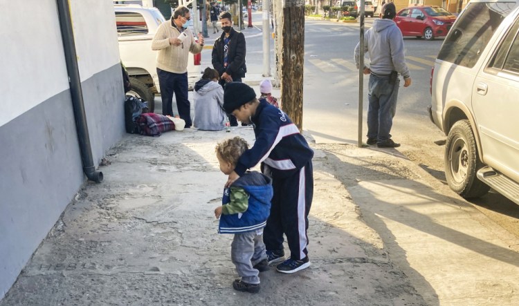 Honduran boys, whose family is seeking asylum in the U.S., play on the sidewalk in Tijuana, Mexico, on Feb. 8. The Biden administration has rolled back several Trump-era policies, but White House Press Secretary  Jen Psaki said at a recent briefing that "now is not the time to come and the vast majority of people will be turned away.”  