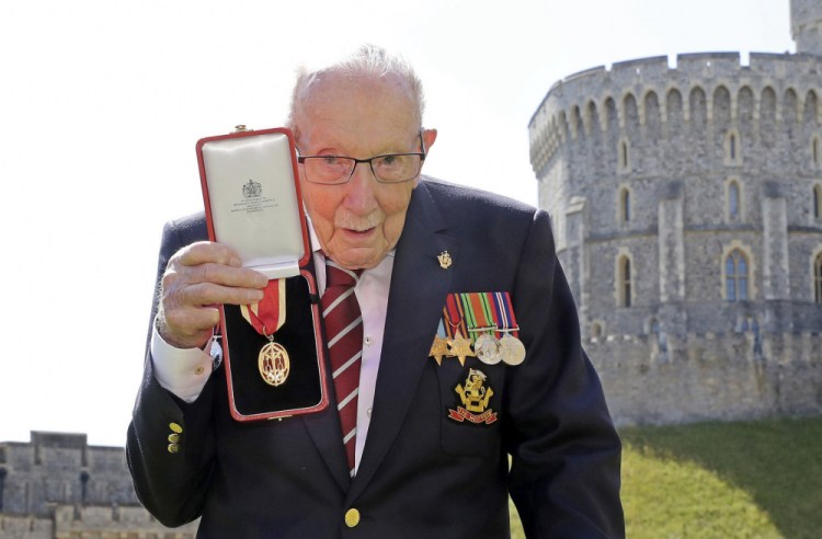 Captain Sir Thomas Moore poses for the media after receiving his knighthood from Britain's Queen Elizabeth, during a ceremony at Windsor Castle in Windsor, England on July 17. 