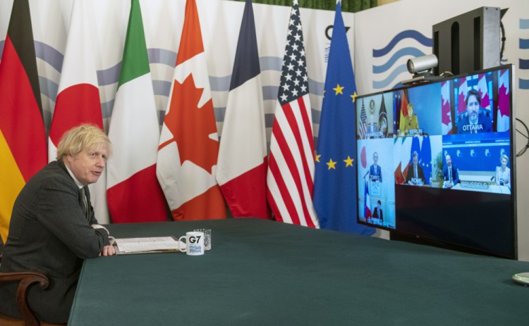 Britain's Prime Minister Boris Johnson hosts a virtual meeting of G7 world leaders, from within the Cabinet Room at Downing Street in London, Friday Feb. 19.  