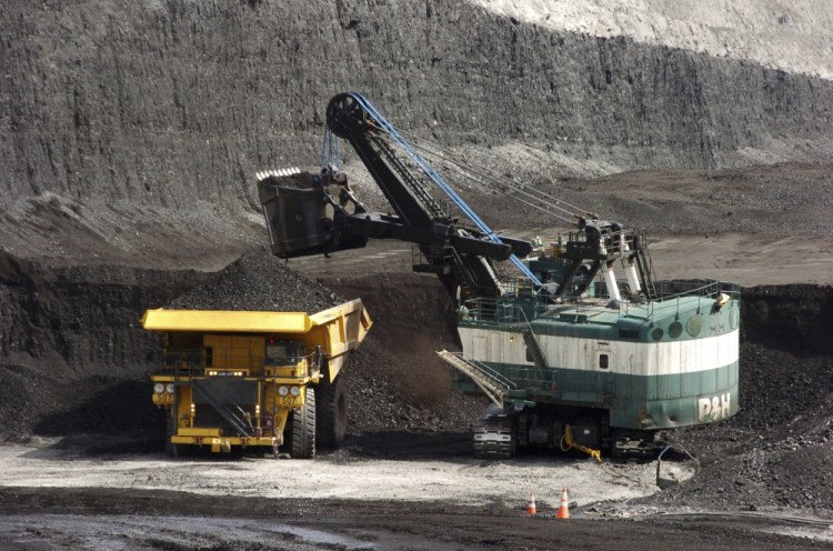 A mechanized shovel loads a truck with coal at the Spring Creek coal mine near Decker, Mont. 

