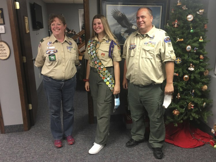 Isabella Tunney, center, with Bev Verweg, her scoutmaster, and Brian Reiners, the scoutmaster of the corresponding linked boy troop, in Edina, Minn. 
