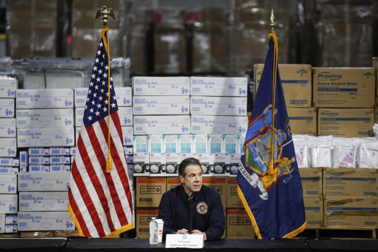 Gov. Andrew Cuomo speaks during a news conference against a backdrop of medical supplies March 24 in New York.

