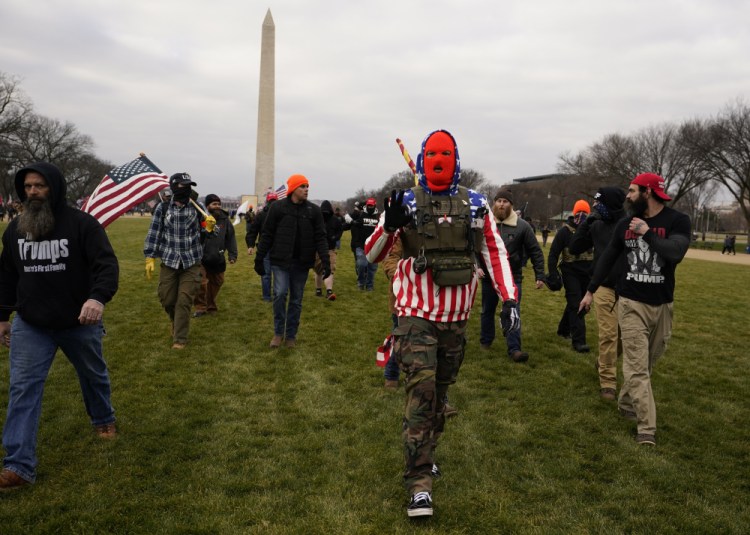 People march with those who say they are members of the Proud Boys as they attend a rally in Washington in support of President Trump on Jan. 6. In designating the group a terrorist entity, Canada noted that group members played a pivotal role in the violent breach of the U.S. Capitol building that day. 