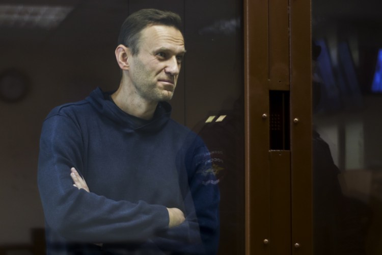 In this photo provided by the Babuskinsky District Court, Russian opposition leader Alexei Navalny stands in a cage during a hearing on his charges for defamation, in the Babuskinsky District Court in Moscow, Russia, Friday, Feb. 5. 