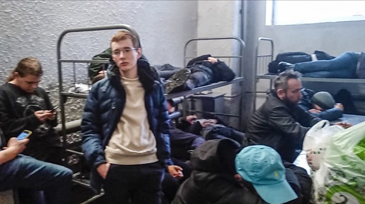 This image taken from a video filmed by Dmitry Shelomentsev shows, a group of detained people inside the deportation centre Sakharovo, 70km south-west of Moscow which was urgently transformed into a detention center in the absence of prison space, in Moscow, Russia, Thursday, Feb. 4. Dmitry Shelomentsev was among those who had to wait in a police bus for hours at Sakharavo before being taken in. Sentenced to 15 days in jail for participating in the Tuesday rally, Shelomentsev messaged the AP reporter on Feb. 4, 2021 morning from a cell for eight inmates where 28 people were held, awaiting transfer to smaller ones. 