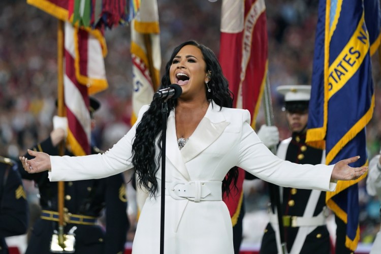 Demi Lovato performs the national anthem before the NFL Super Bowl 54 in Miami Gardens, Fla., in 2020. Lovato reveals publicly for the first time details about her near-fatal drug overdose in 2018 in “Demi Lovato: Dancing With the Devil,” a four-part docuseries debuting March 23, 2021, on YouTube Originals.