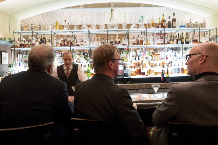 A bartender talks to a customer at the Gotham Bar and Grill on Nov. 27, 2018, in New York. The Manhattan upscale restaurant hopes to reopen by summer 2021 if government regulations permit, but will likely have just 35 staffers instead of the 100 the restaurant had before it closed in March 2020.