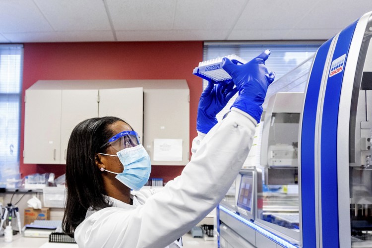 Clinical lab scientist Selam Bihon processes upper respiratory samples from patients suspected of having COVID-19 at the Stanford Clinical Virology Laboratory on Wednesday in Palo Alto, Calif. 