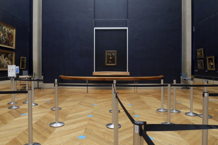 Leonardo da Vinci's "Mona Lisa" hangs on the wall in a deserted Louvre museum in Paris.
