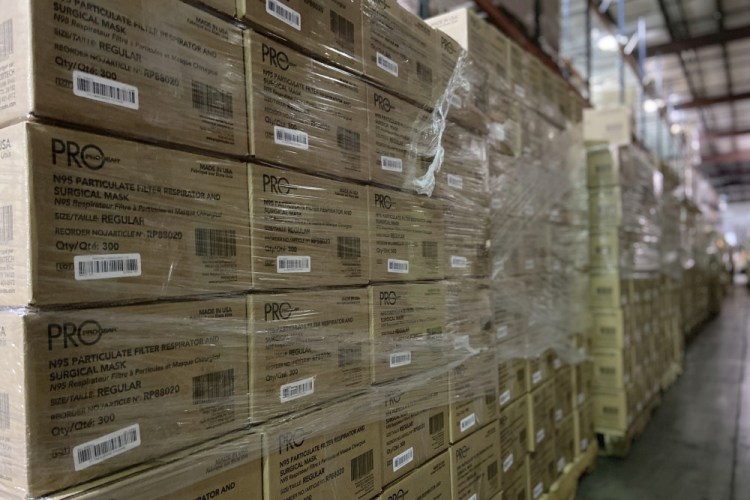 This Friday, Feb. 5, 2021 photo provided by Prestige Ameritech shows boxes of the company's N95 masks in warehouse storage at North Richland Hills, Texas, outside of Fort Worth. One year into the COVID-19 pandemic, the U.S.  finds itself with many millions of N95 masks pouring out of American factories and heading into storage. Yet there still aren’t nearly enough in ICU rooms and hospitals.