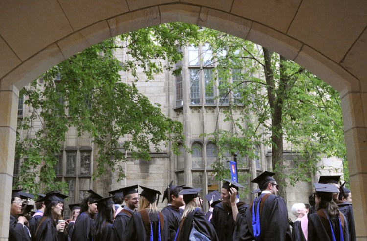 Future graduates wait for the procession to begin for commencement at Yale University in New Haven, Conn. in 2010. The Biden Justice Department says it is dismissing its discrimination lawsuit against Yale University. The Trump administration alleged last year that the university was illegally discriminating against Asian American and white applicants. 