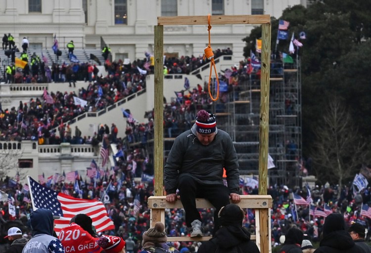A man climbs down after being photographed with a noose at the U.S. Capitol on Jan. 6. 2021. MUST CREDIT: Washington Post photo by Ricky Carioti