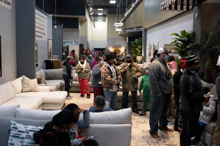 People wait in line for food at a Gallery Furniture store in Houston. 