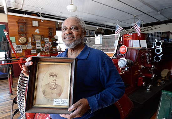 Bob Greene of South Portland holds a photo of his ancestor, William Wilberforce Ruby, who is credited with discovering the Great Fire of 1866 and later became a firefighter and city leader.