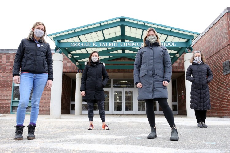 PORTLAND, ME - MARCH 3: Four teachers Gerald E. Talbot Community School stand masked and socially distanced at the facility's entrance on Wednesday. The teachers feel strongly that school staff should be prioritized for coronavirus vaccinations. Will Maine change its plans following President Biden's directive Tuesday that states prioritize educators? From left: third-grade teacher Katie Cestaro, second-grade teacher Taryn Southard, fourth-grade teacher Cindy Soule and fifth-grade teacher Jes Ellis. (Staff photo by Ben McCanna/Staff Photographer)