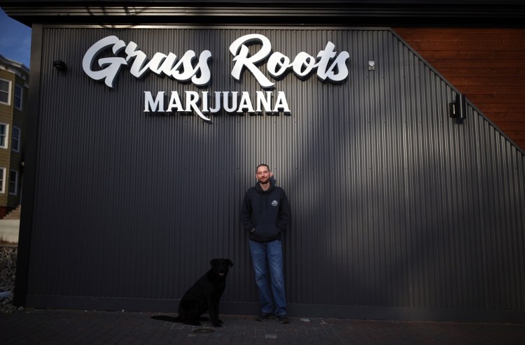 Jim Hamilton, owner Grass Roots, stands outside his soon-to-be-opened business at 377 St. John St. in Portland with his dog, Carley. With the approval of two licenses on Wednesday, Portland's recreational marijuana market is officially open for business, nearly five months after the statewide market launch.