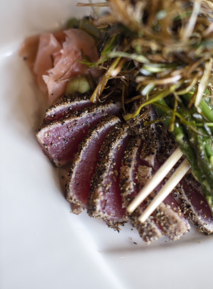 PORTLAND, ME - MARCH 26: David TurinÕs pepper crusted sushi rare tuna served with cold sesame-peanut soba noodles, sesame asparagus, frizzled leeks and Szechwan citrus sauce at his restaurant in Monument Square on Friday, March 26, 2021. Turin said the dish has been on his menu since 1992. (Staff photo by Brianna Soukup/Staff Photographer)