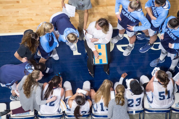 University of Maine head coach Amy Vachon huddles with her players during a timeout. The 2020-21 team had the highest grade-point average of any women's basketball team in the nation. 