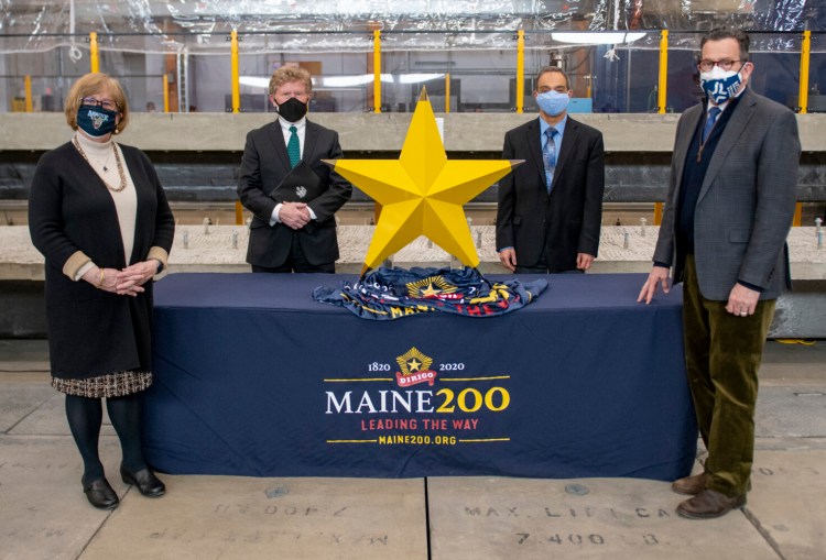 University of Maine presents 3D-printed Dirigo Star to the Maine Bicentennial Commission for Maine Bicentennial Time Capsule. On hand for the presentation, from left to right, are Joan Ferrini-Mundy, University of Maine System vice chancellor for research and innovation, and UMaine president; Sen. Bill Diamond, chairman of the Maine Bicentennial Commission; Habib Dagher, executive director of the UMaine Advanced Structures and Composites Center; and Dannel Malloy, UMS chancellor.