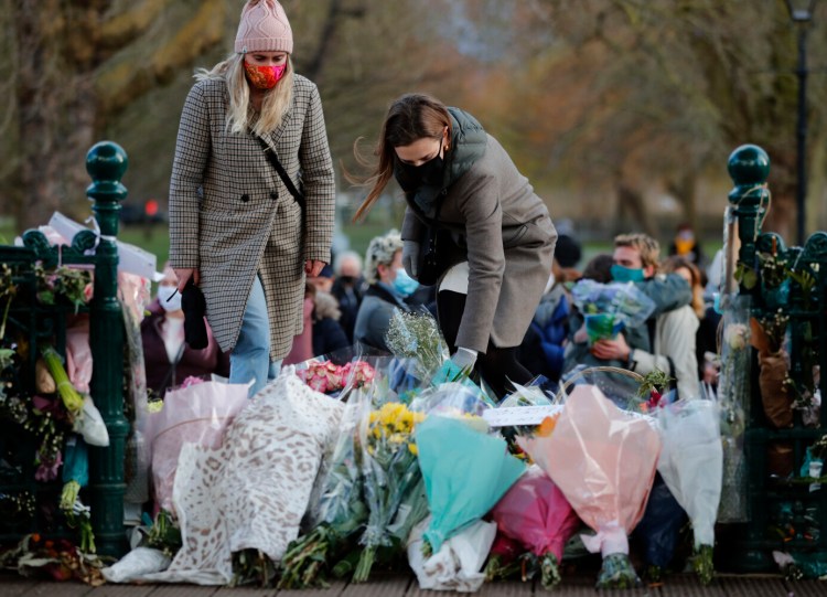 People leave floral tributes at the bandstand in Clapham Common, after a vigil for Sarah Everard was officially cancelled in London on Saturday.
