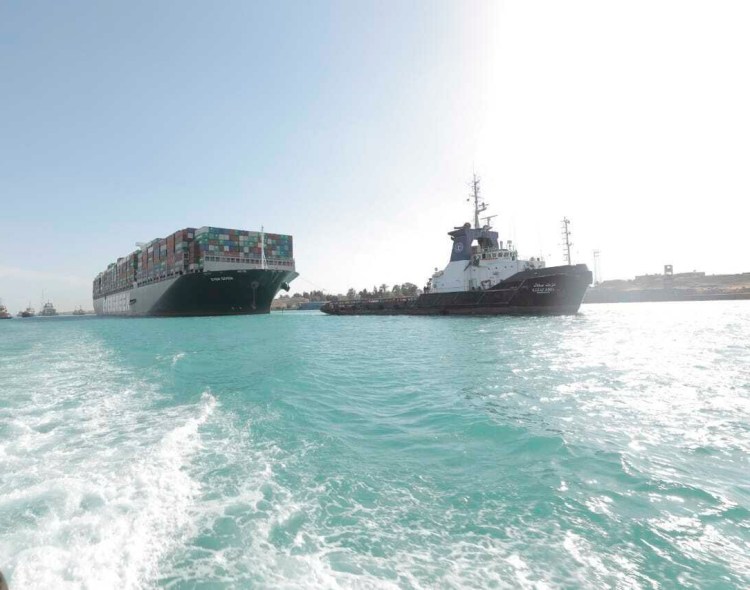 The Ever Given, a Panama-flagged cargo ship is accompanied by Suez Canal tugboats on Monday after it was freed. 