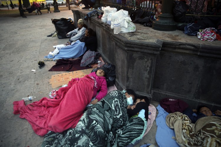 Migrants sleep under a gazebo at a park in the Mexican border city of Reynosa, Saturday. Dozens of migrants who earlier tried to cross into the U.S. in order to seek asylum have turned this park into an encampment for those expelled from the U.S. under pandemic-related presidential authority.