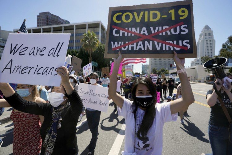 Protestors march at a rally against Asian hate crimes past the Los Angeles Federal Building in downtown Los Angeles , Saturday, March 27. The gathered crowd demanded justice for the victims of the Atlanta spa shooting and for an end to racism, xenophobia and misogyny. 