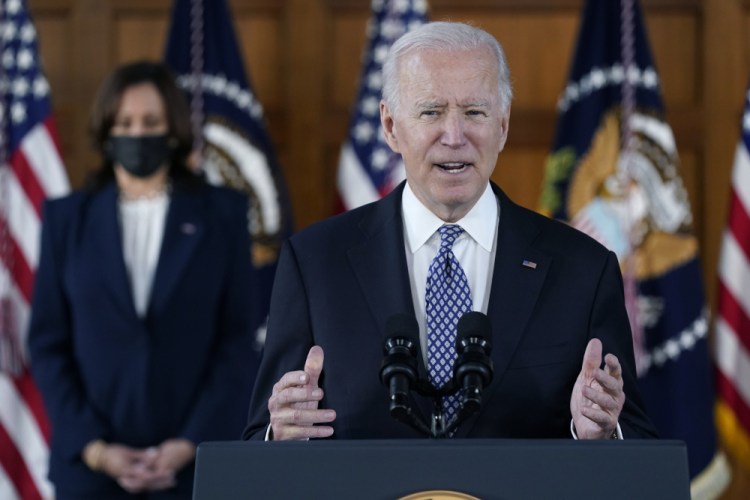 President Biden speaks after meeting with leaders from Georgia's Asian American and Pacific Islander community on Friday at Emory University in Atlanta. Standing behind him is Vice President Kamala Harris. 